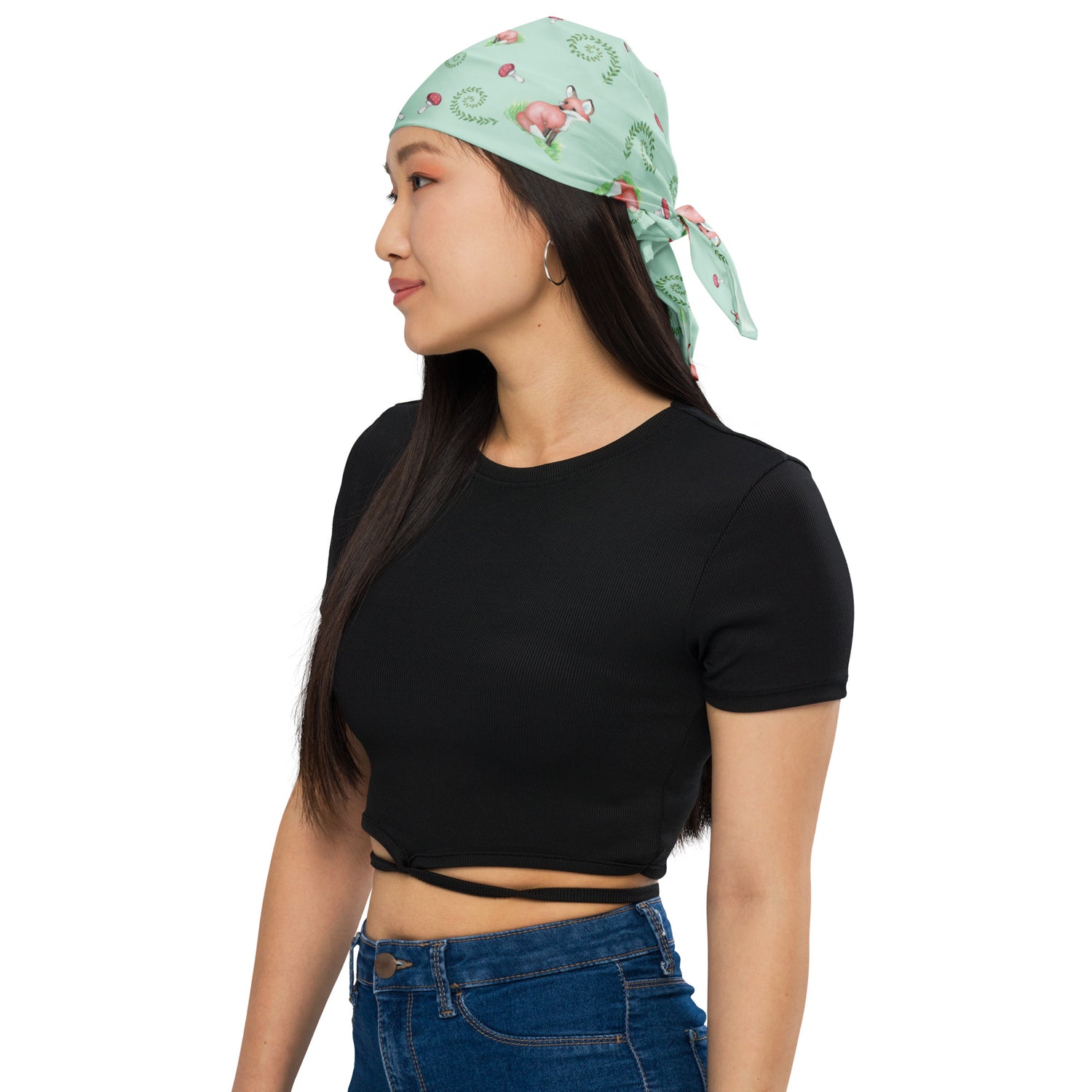 Forest fox bandana with watercolor foxes, mushrooms and ferns on light green fabric. Single-sided print. Made from microfiber polyester.  Shown on head of female model.