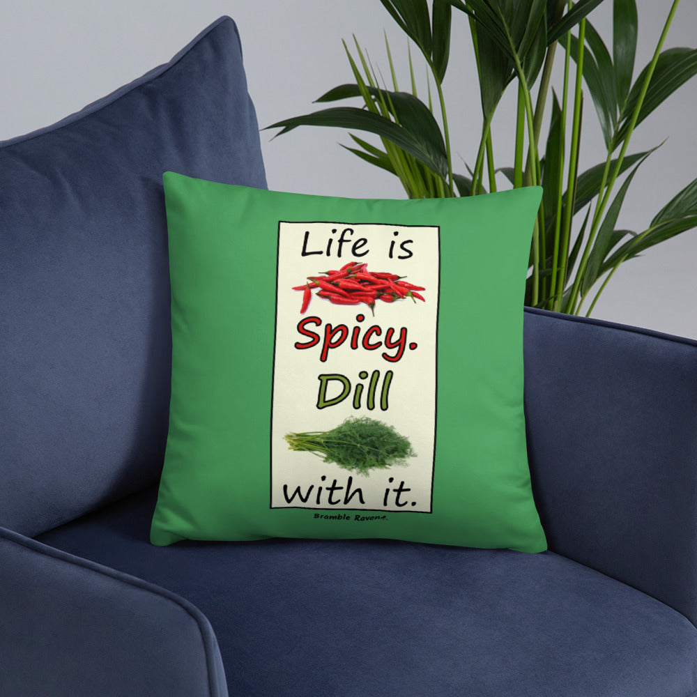 Life is spicy. Dill with it. Phrase with images of chili peppers and dill weed. Rectangular frame for saying on green background. 18 by 18 inch accent pillow. Double sided image. Shown on a blue couch.