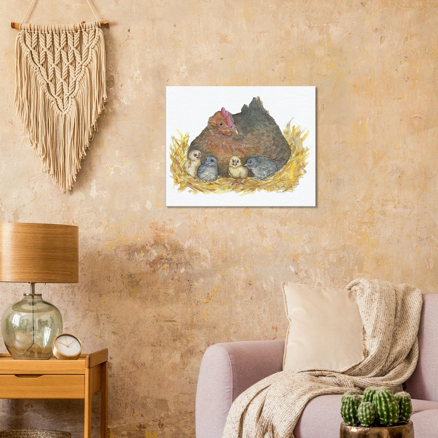 24 by 30 inch slim canvas Mother Hen print. Features a watercolor mother hen and her four chicks in a nest. Shown on tan wall above pink armchair and lamp.