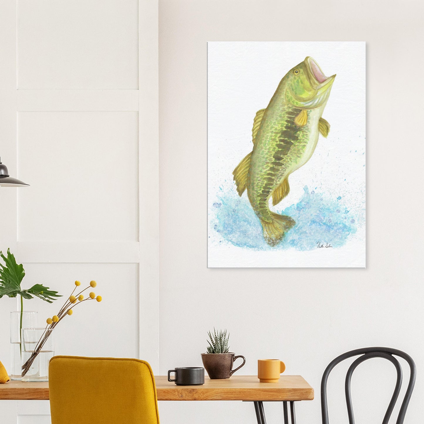 28 by 40 inch slim canvas wall art print featuring a watercolor painting of a largemouth bass leaping from the water. Shown on wall above wooden table and kitchen chairs.