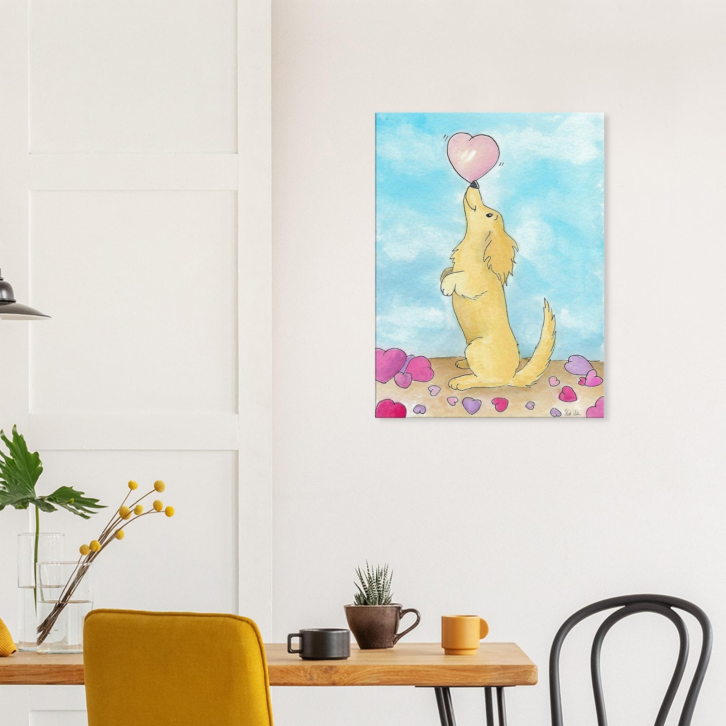 24 by 32 inch canvas wall art print of Heather Silver's watercolor painting, Puppy Love. It features a cute dog balancing a pink heart on its nose against a blue sky background. Canvas shown on wall above kitchen table and chairs.