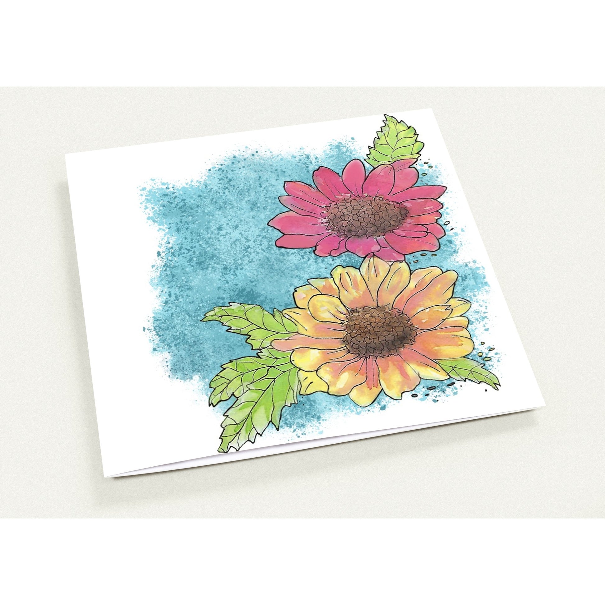 5.25 by 5.25 inch Gerber daisies set of 10 greeting cards and 10 envelopes. Printed on glossy paperboard. Front has a print of watercolor Gerber daisies on a blue accent. Inside has a blue watercolor border with daisy accents.