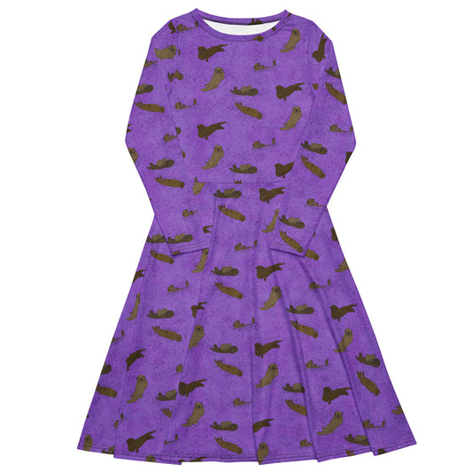 Long sleeve midi dress with fitted waist, flared bottom, and side pockets. Features a patterned design of sea otters on a textured purple background.