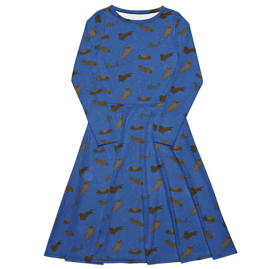 Long sleeve midi dress with fitted waist, flared bottom, and side pockets. Features a patterned design of sea otters on an ocean blue background.