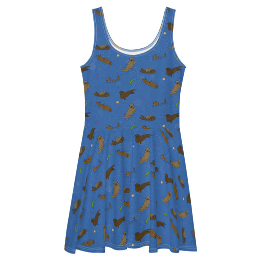 Sleeveless skater dress that features sea otters on on ocean blue background. The soft fabric is made of polyester and spandex, so it is both soft and stretchy. It has a mid-thigh length flared skirt and elastic waistline.