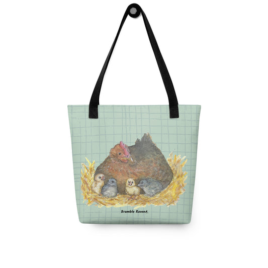 15 by 15 inch sturdy polyester tote bag. Features watercolor mother hen and chicks on a green crosshatched background. Has black cotton bull denim handles. Shown hanging on a hook.