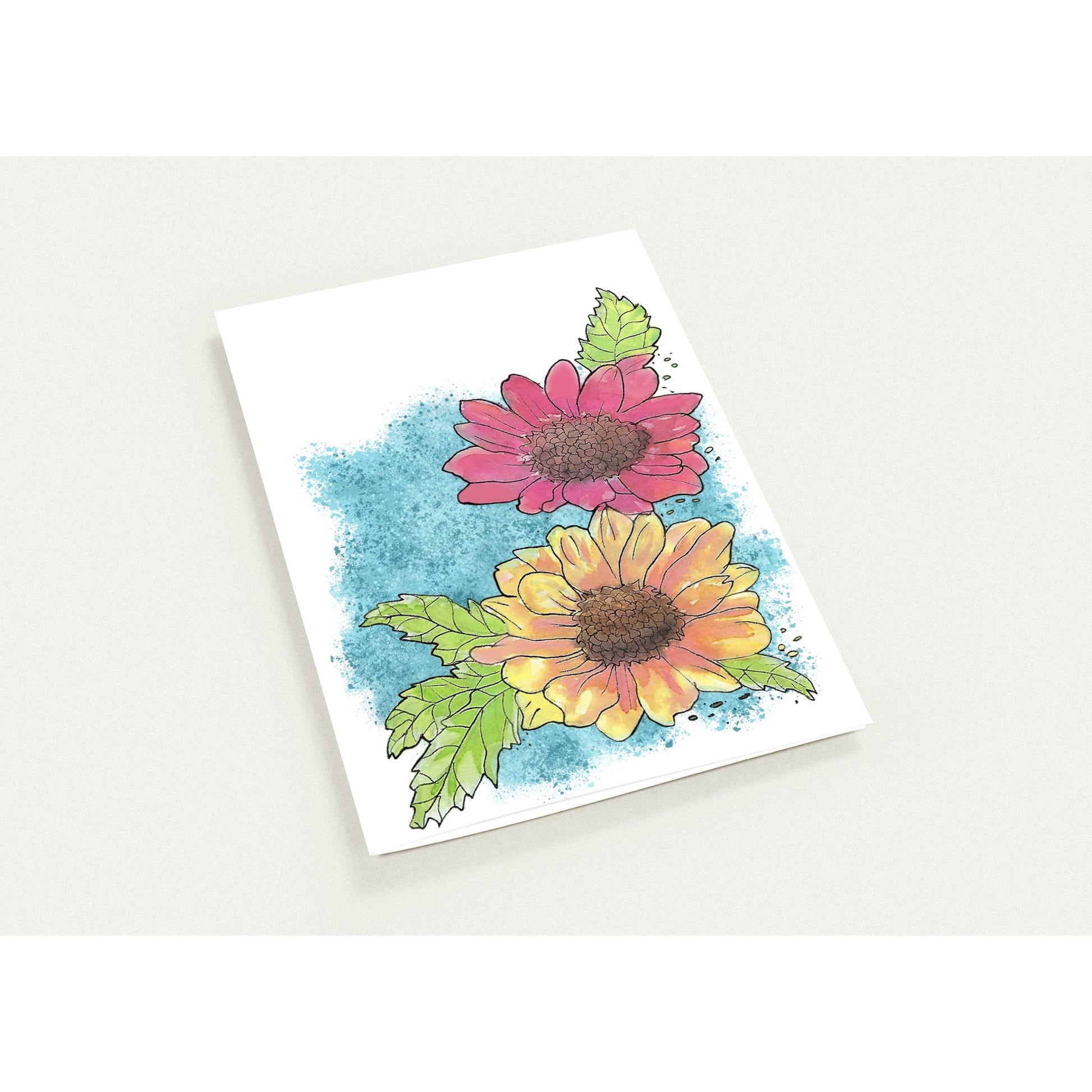 5.5 by 8.5 inch Gerber daisies set of 10 greeting cards and 10 envelopes. Printed on glossy paperboard. Front has a print of watercolor Gerber daisies on a blue accent. Inside has a blue watercolor border with daisy accents.