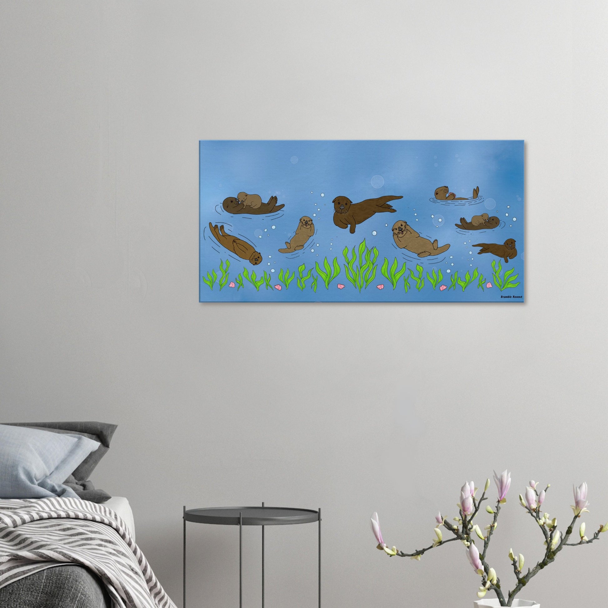 20 by 40 inch slim canvas wall art print of sea otters swimming along the seabed. Shown on wall above grey nightstand, grey bed, and budding flower decor.