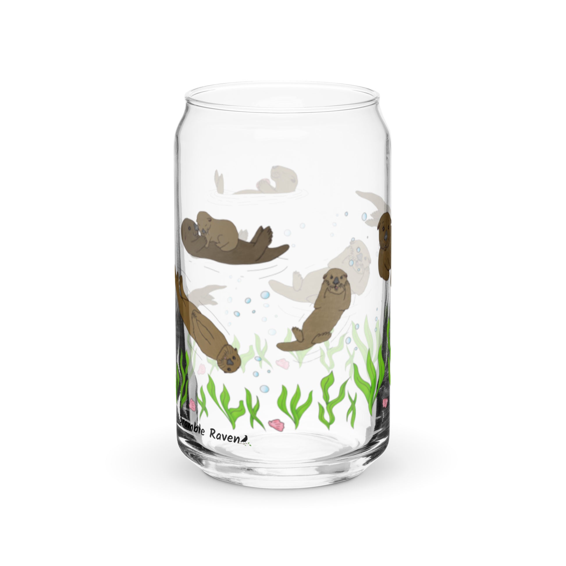 Can-shaped glass holds 16 fluid ounces. Has a design of sea otters swimming above the seaweed with bubble and shell accents. Right side view.
