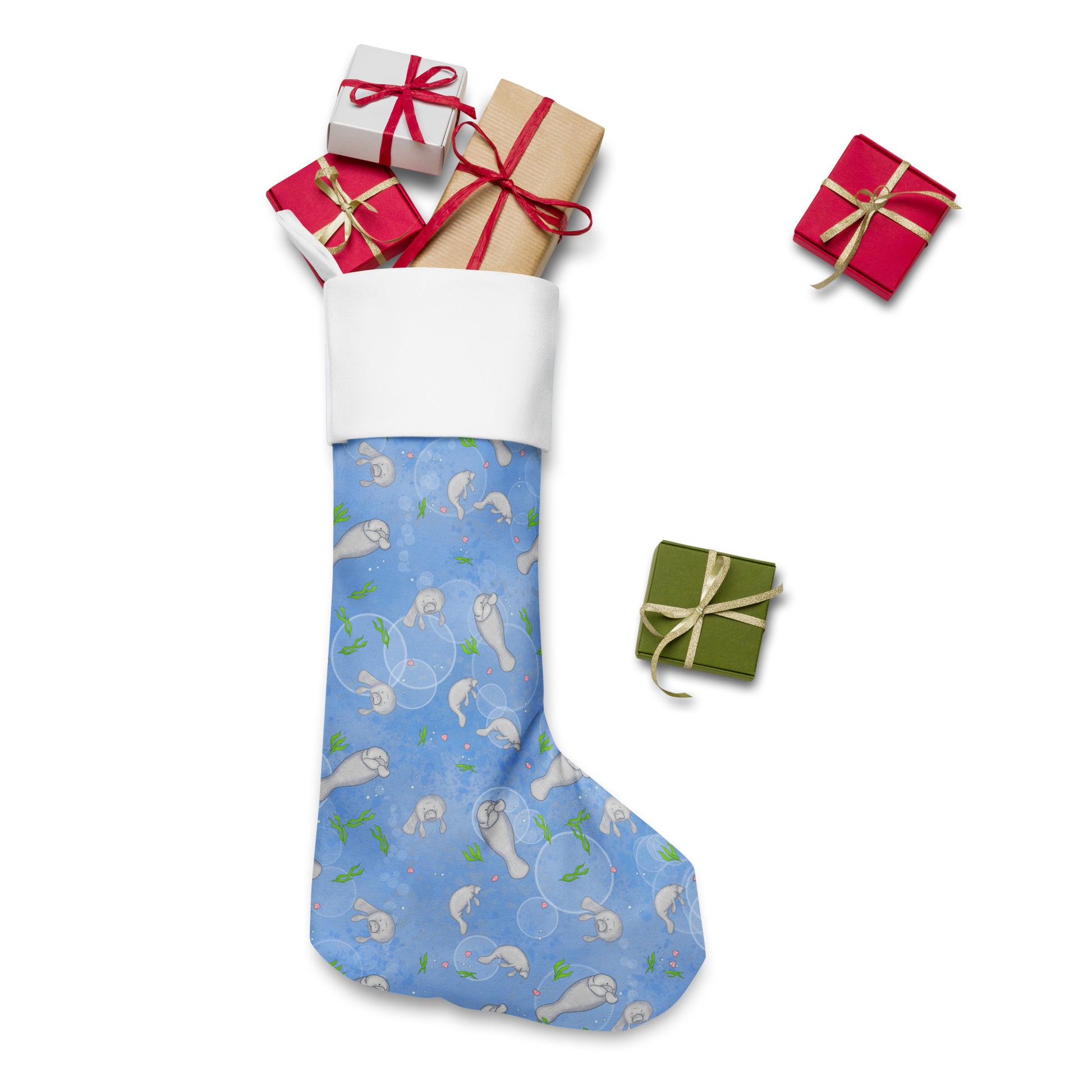 Limited Edition Manatee Christmas Stocking.  7 by 18 inches. The front has a hand-illustrated manatee design with an off-white polyester fabric on the back. It has a white fold-over cuff and a loop for hanging. Shown stuffed with presents.
