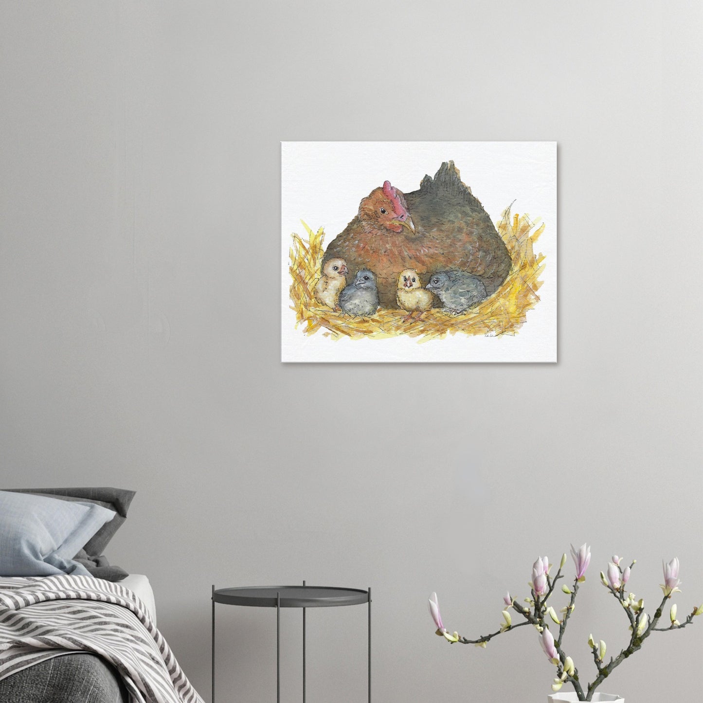 24 by 30 inch slim canvas Mother Hen print. Features a watercolor mother hen and her four chicks in a nest. Shown on wall above bed, grey side table, and blooming branch.