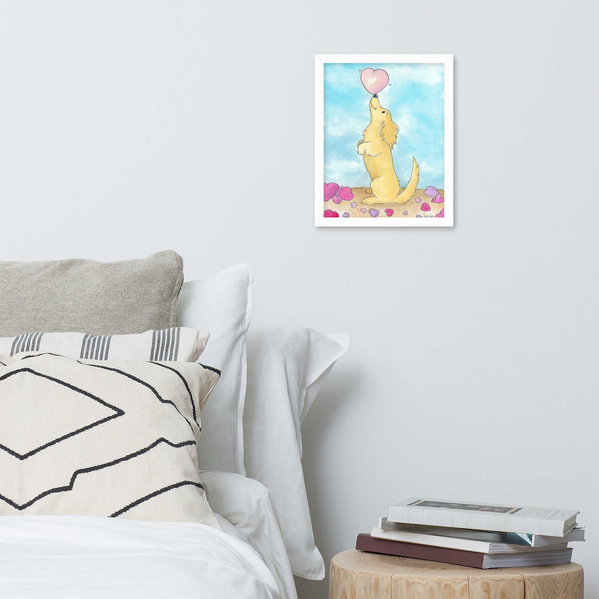 Framed watercolor art print entitled Puppy Love.  11 by 14 inch print in white ayous wood frame. Has acrylite cover to protect the art print. Hanging hardware included. Shown on wall above bed and nightstand.