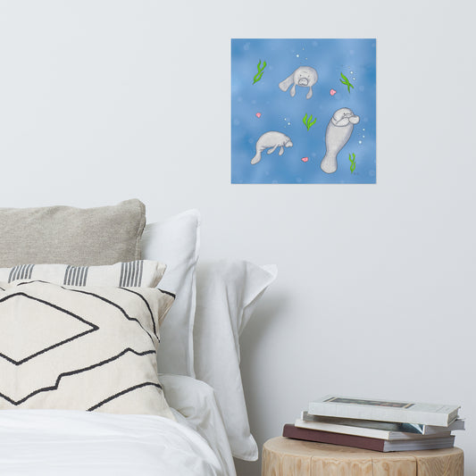 16 by 16 inch poster print of illustrated manatees by Heather Silver. Shown on wall above white bedding and wooden side table.