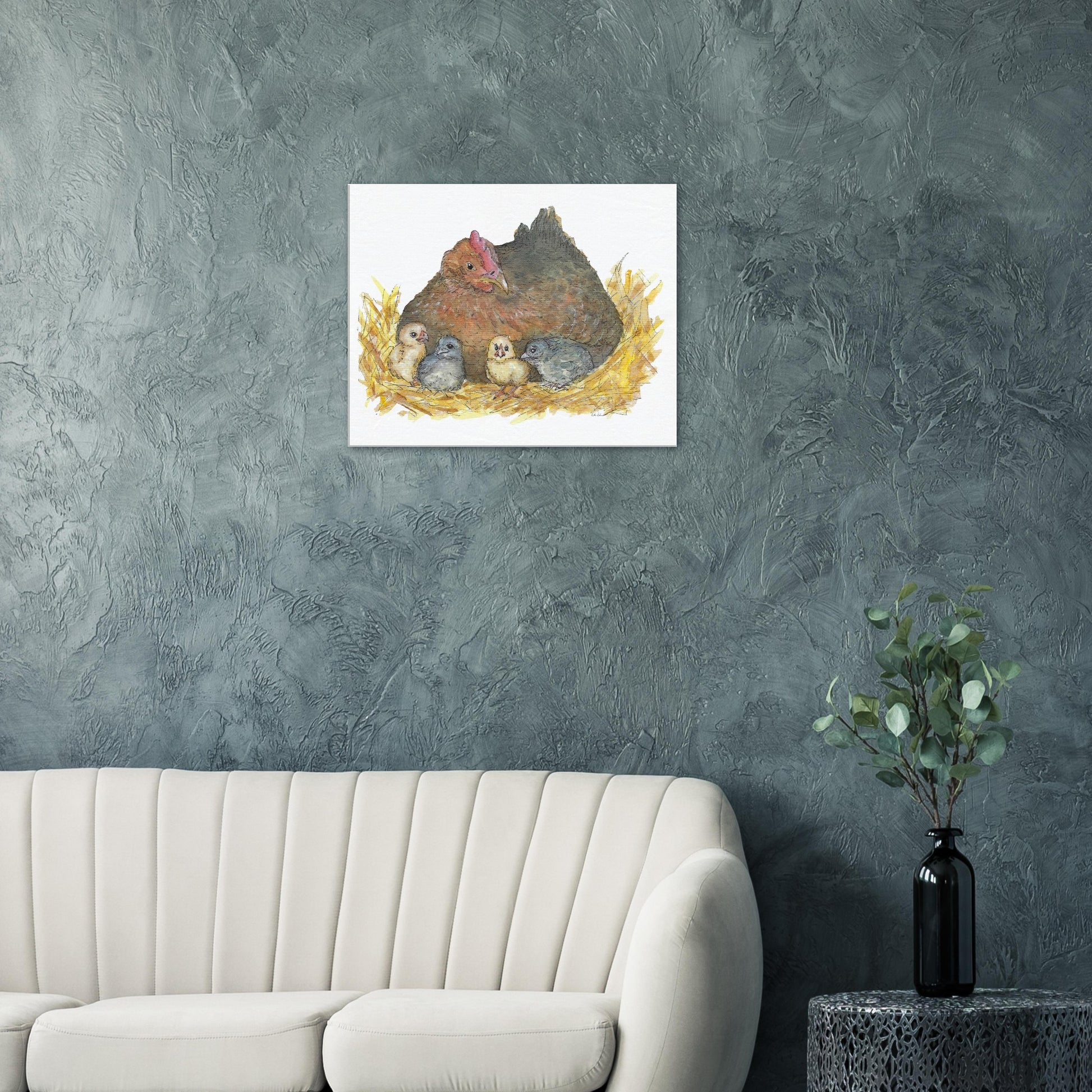24 by 30 inch slim canvas Mother Hen print. Features a watercolor mother hen and her four chicks in a nest. Shown on green wall above white sofa.