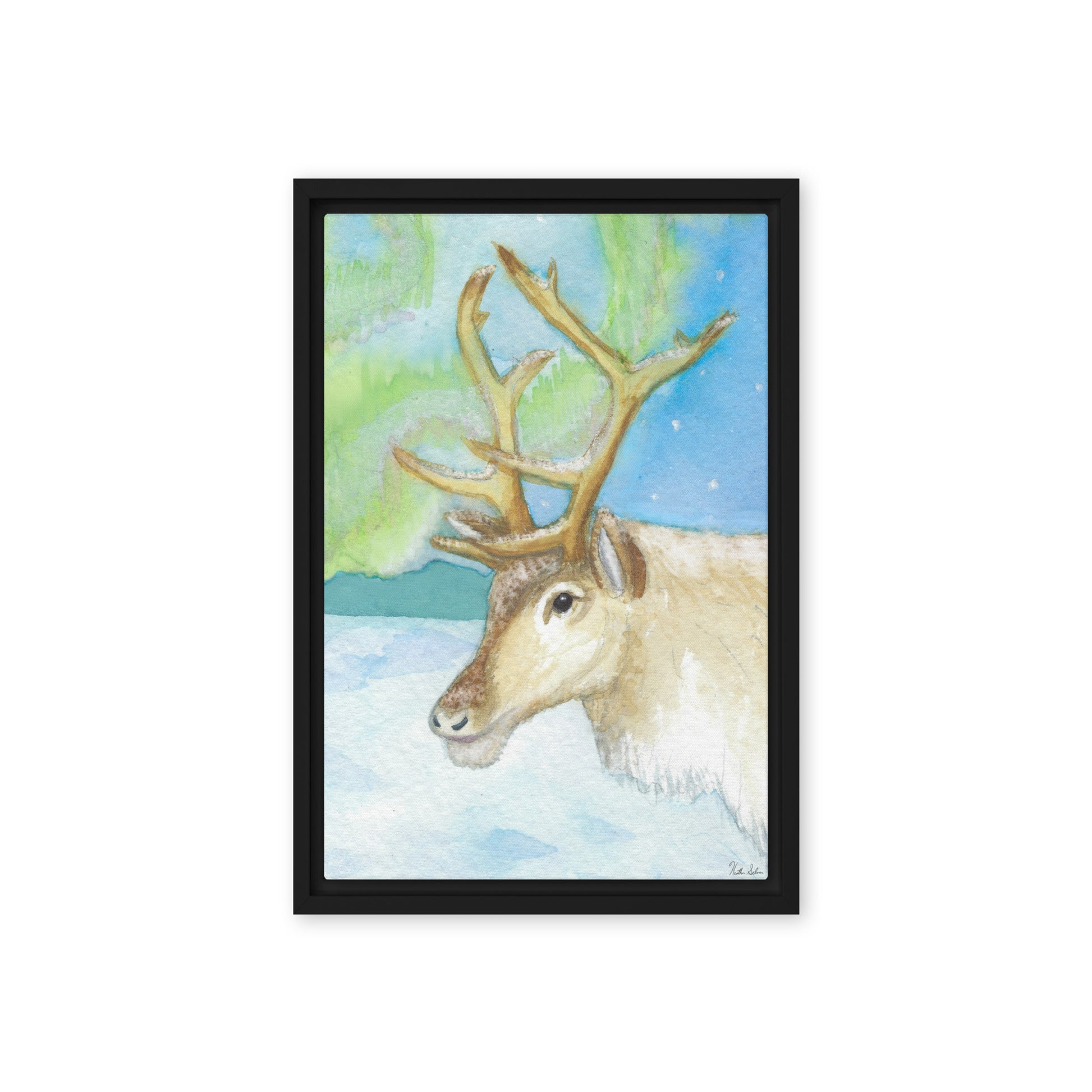 12 by 18 inch framed canvas art print of Heather Silver's Northern Lights Reindeer.  Canvas print mounted in a black pine frame. Hanging hardware included.