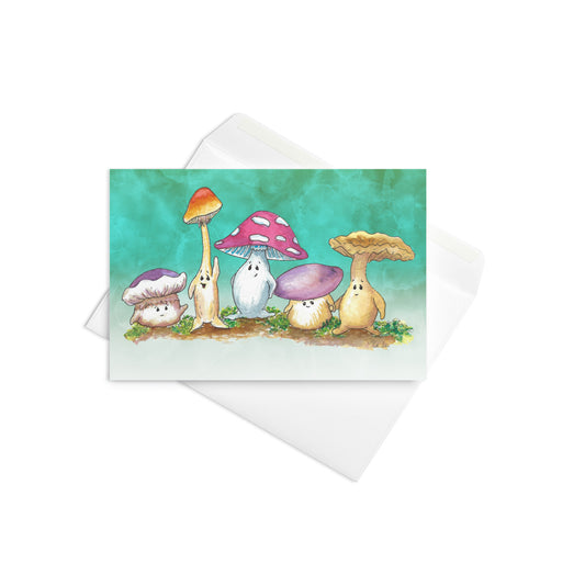4 by 6 inch greeting card with white envelope. Features watercolor print of Mushy and his mushroom friends against a green gradient background. Inside is blank. Made of durable paperboard with vibrant printing.