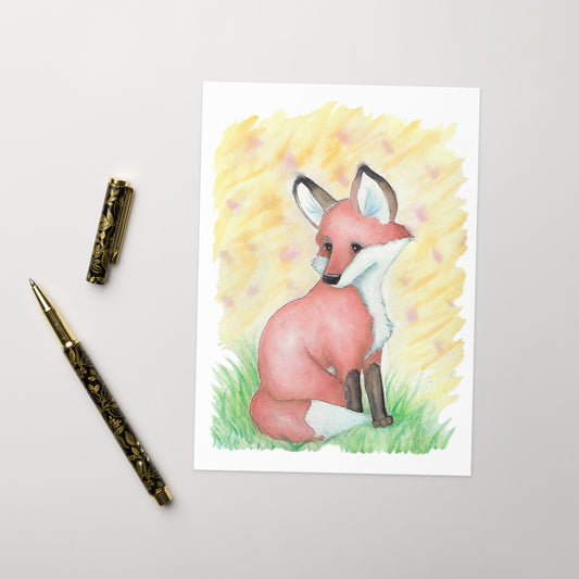 Pack of ten 5 x 7 inch greeting cards with ten envelopes. Front of card has watercolor fox in the grass against an orange and yellow summer sunset background. Inside is blank. Cards are 130 lb 350 gsm coated paperboard with vibrant printing.  Shown on tabletop by ballpoint pen.