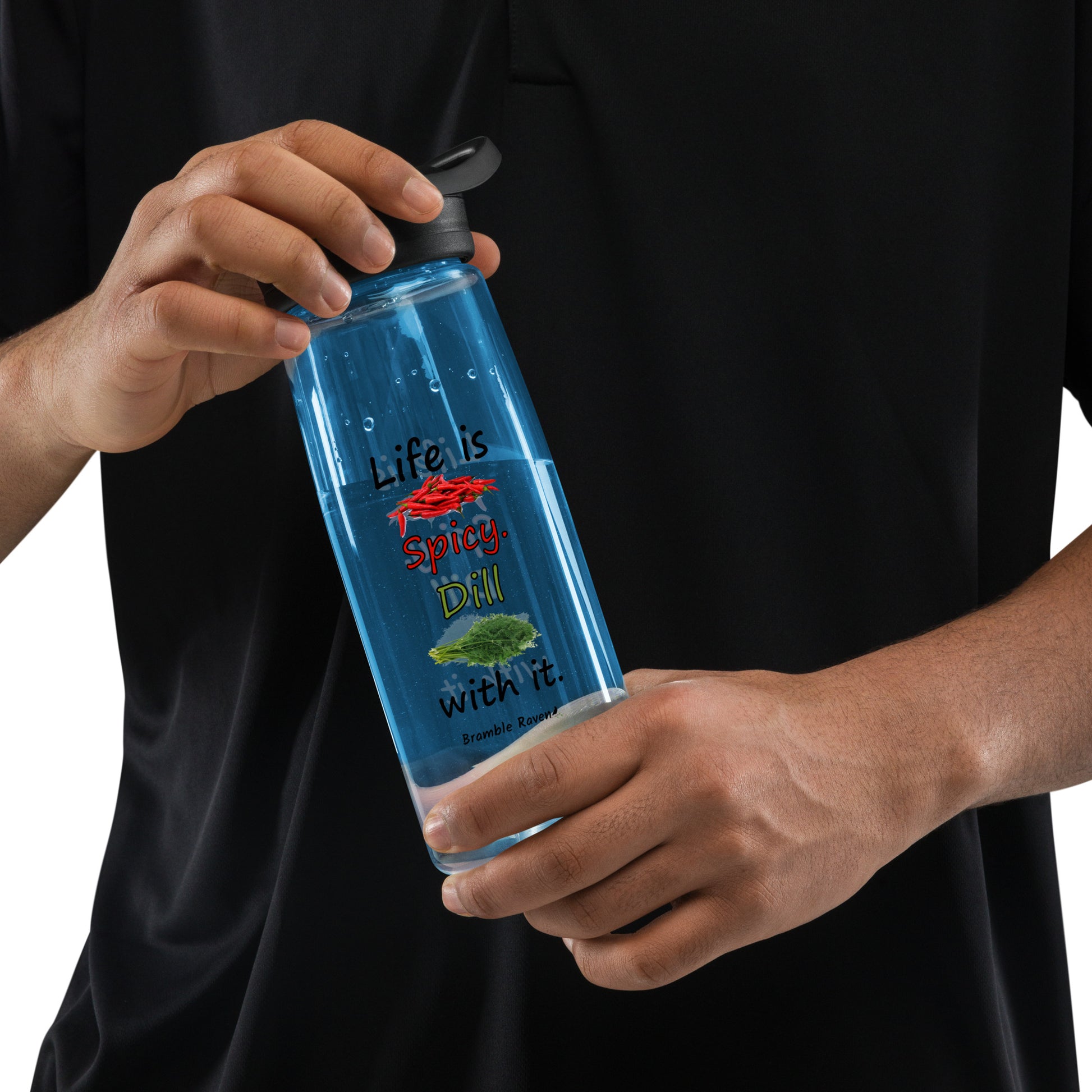 25 ounce sports water bottle with spill-proof lid and bite valve. Dark blue stain and odor-resistant BPA-free plastic. Features double-sided design of "Life is spicy. Dill with it" phrase with peppers and dill weed images. Shown in model's hands.