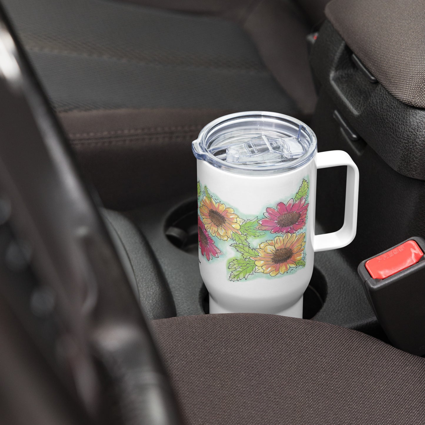 Gerber daisies stainless steel travel mug with handle. Holds 25 ounces and has a BPA-free plastic lid. Shown in car drink holder.