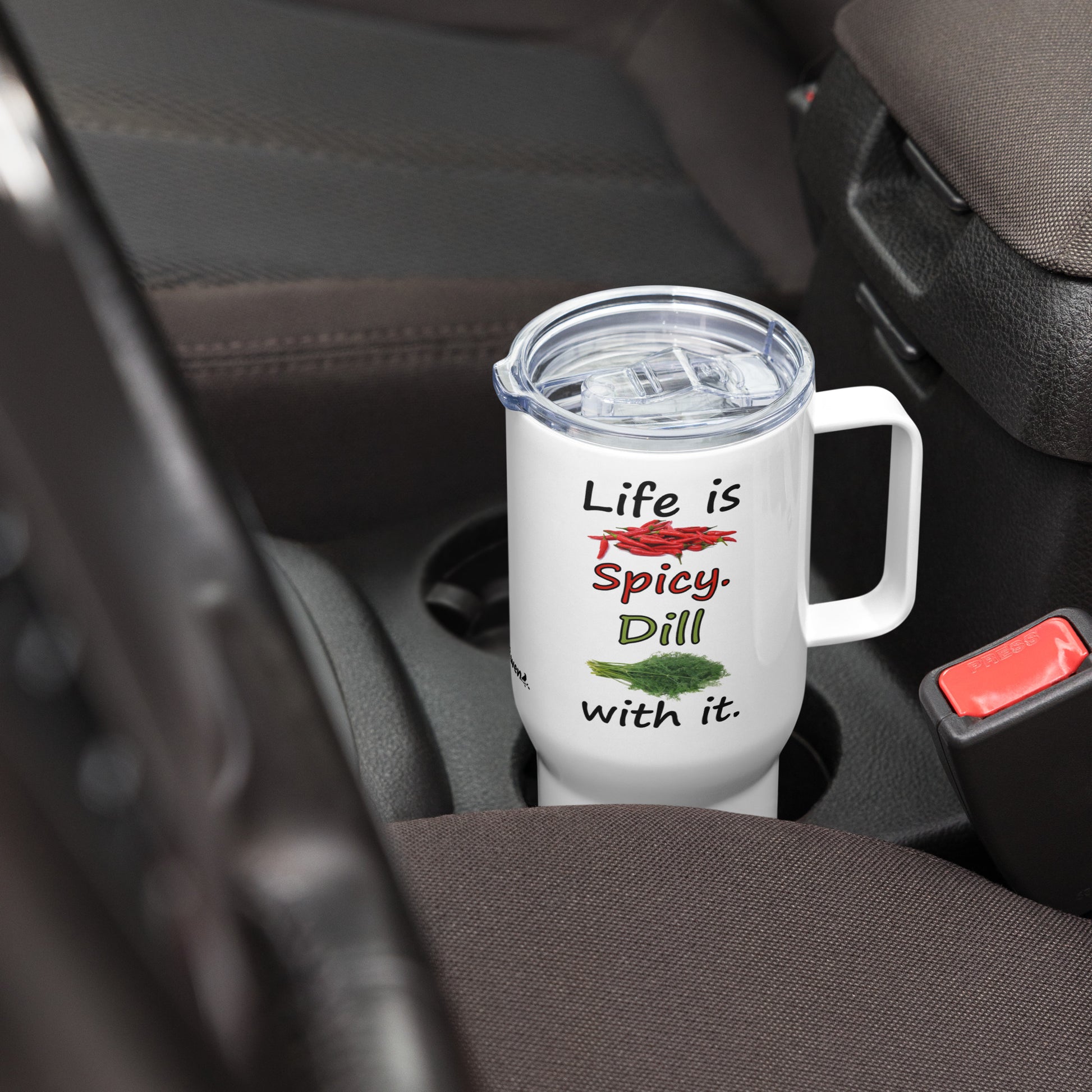 Stainless steel travel mug with handle. Holds 25 ounces of hot or cold liquids. Fits most car cup holders. Features double-sided phrase: Life is spicy. Dill with it, and accompanying chili pepper and dill weed images. Comes with spill proof plastic lid. Shown in car cup holder.