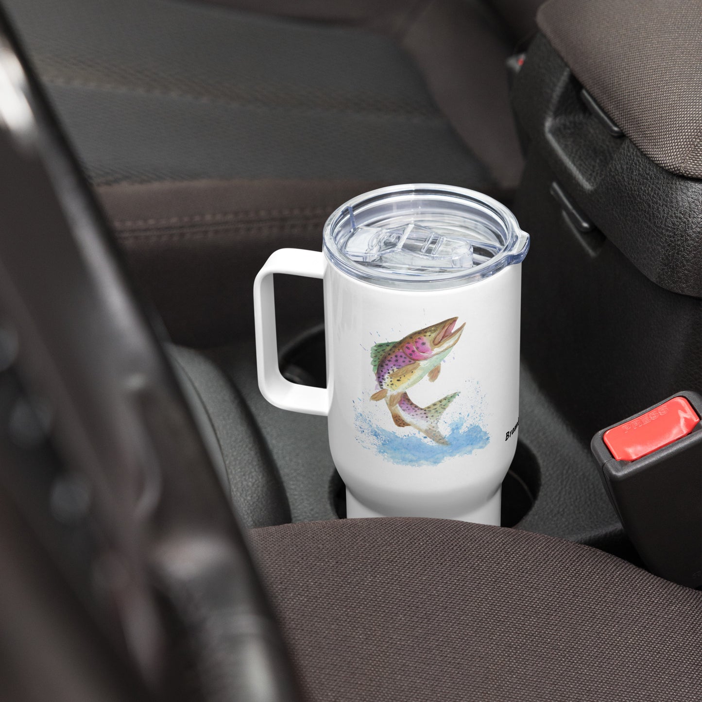 Stainless steel travel mug with handle. Holds 25 ounces of hot or cold drinks. Has print of watercolor rainbow trout fish on both sides. Fits most car cup holders. Comes with spill-proof BPA-free plastic lid. Shown in car cup holder with handle facing left.