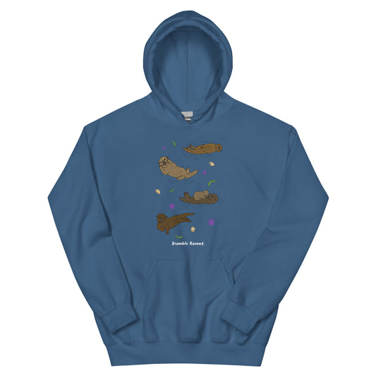 Indigo blue colored unisex hoodie. Features front design of illustrated sea otters, seashells, seaweed and sea urchins. Hoodie has a front pouch pocket and double-lined hood.
