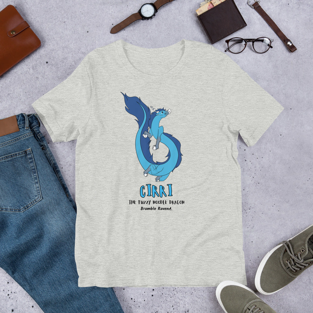 Cirri the Fuzzy Noodle Dragon on an athletic heather grey unisex t-shirt. Shown surrounded by pants, shoes, glasses, a watch, and wallet.
