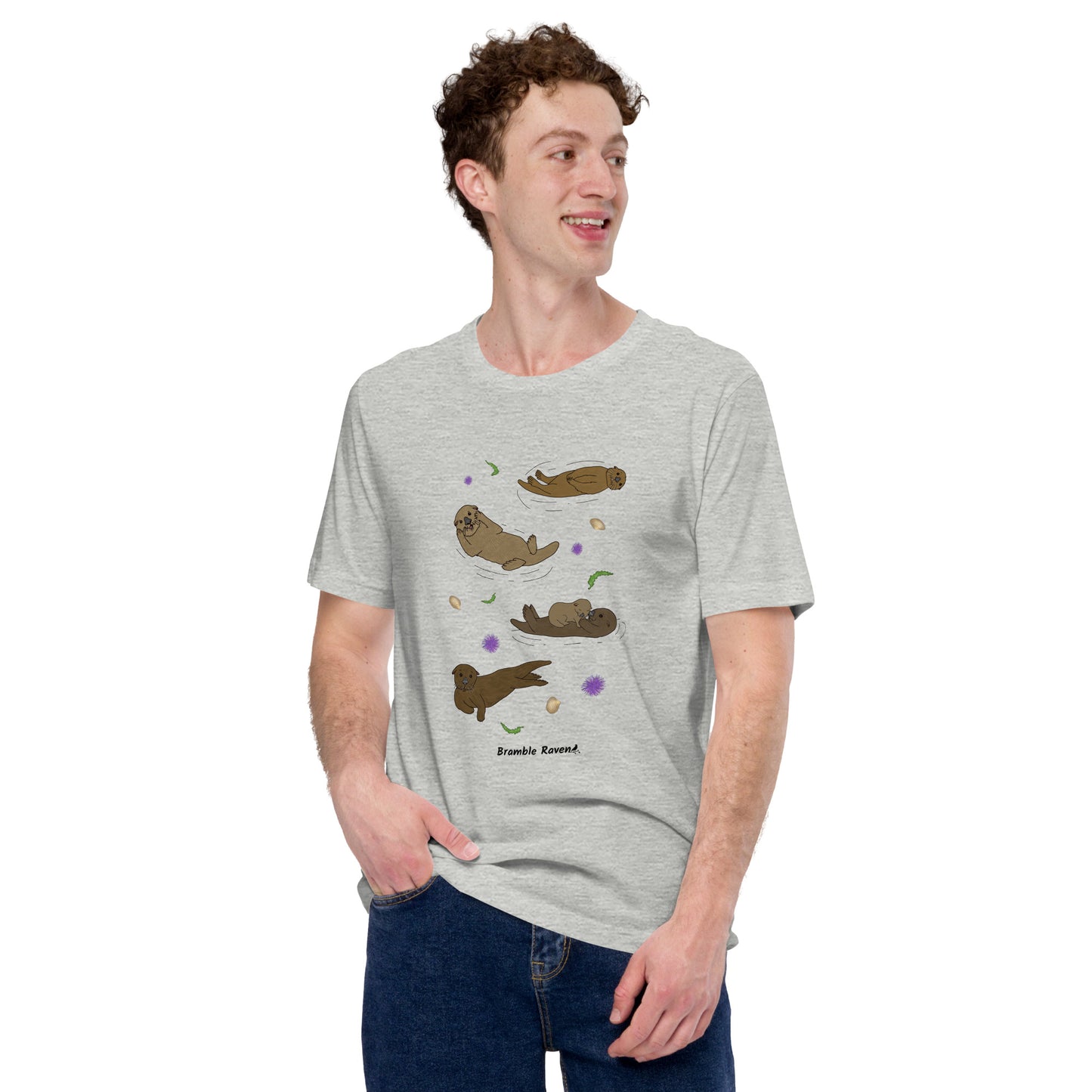 Unisex athletic heather grey colored t-shirt. Features four sea otters with seaweed, shells, and sea urchins. Shown on male model looking right.