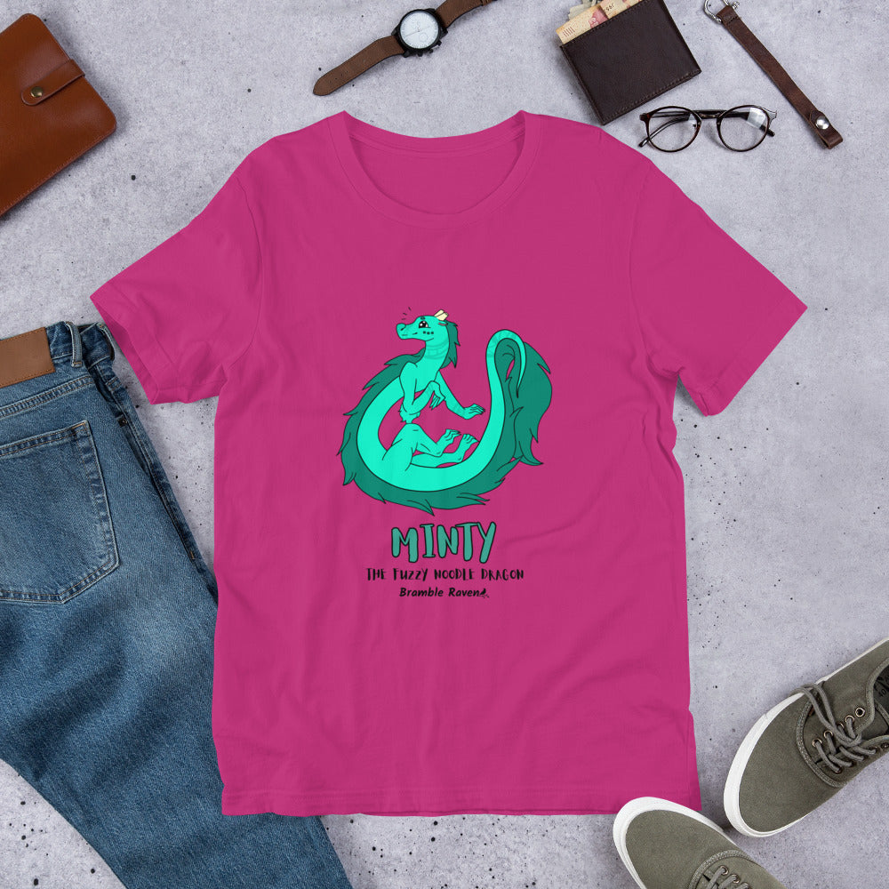 Minty the Fuzzy Noodle Dragon on a berry pink unisex t-shirt. Shown surrounded by pants, shoes, glasses, a watch, and wallet.