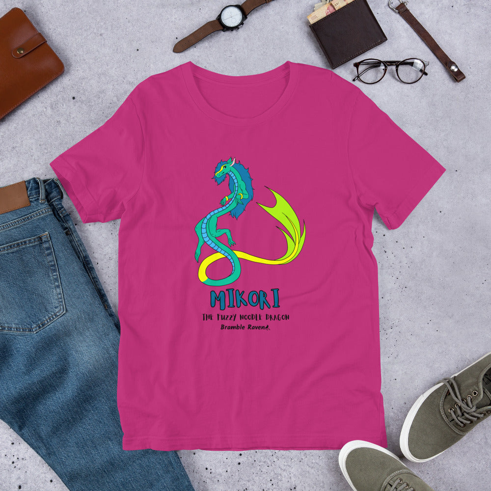 Mikori the Fuzzy Noodle Dragon on a berry pink unisex t-shirt. Shown surrounded by pants, shoes, glasses, a watch, and wallet.