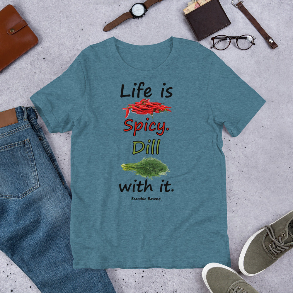 Heather deep teal colored unisex t-shirt. Features text: Life is Spicy. Dill with it. Graphic of chili peppers and dill weed. Made of preshrunk cotton with side seams. Shown on floor by pants, shoes, wallet and glasses.
