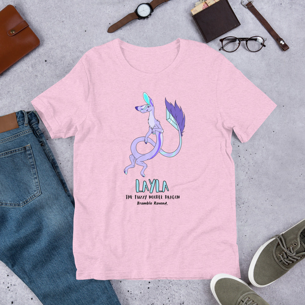 Layla the Fuzzy Noodle Dragon on a prism lilac pink unisex t-shirt. Shown surrounded by pants, shoes, glasses, a watch, and wallet.