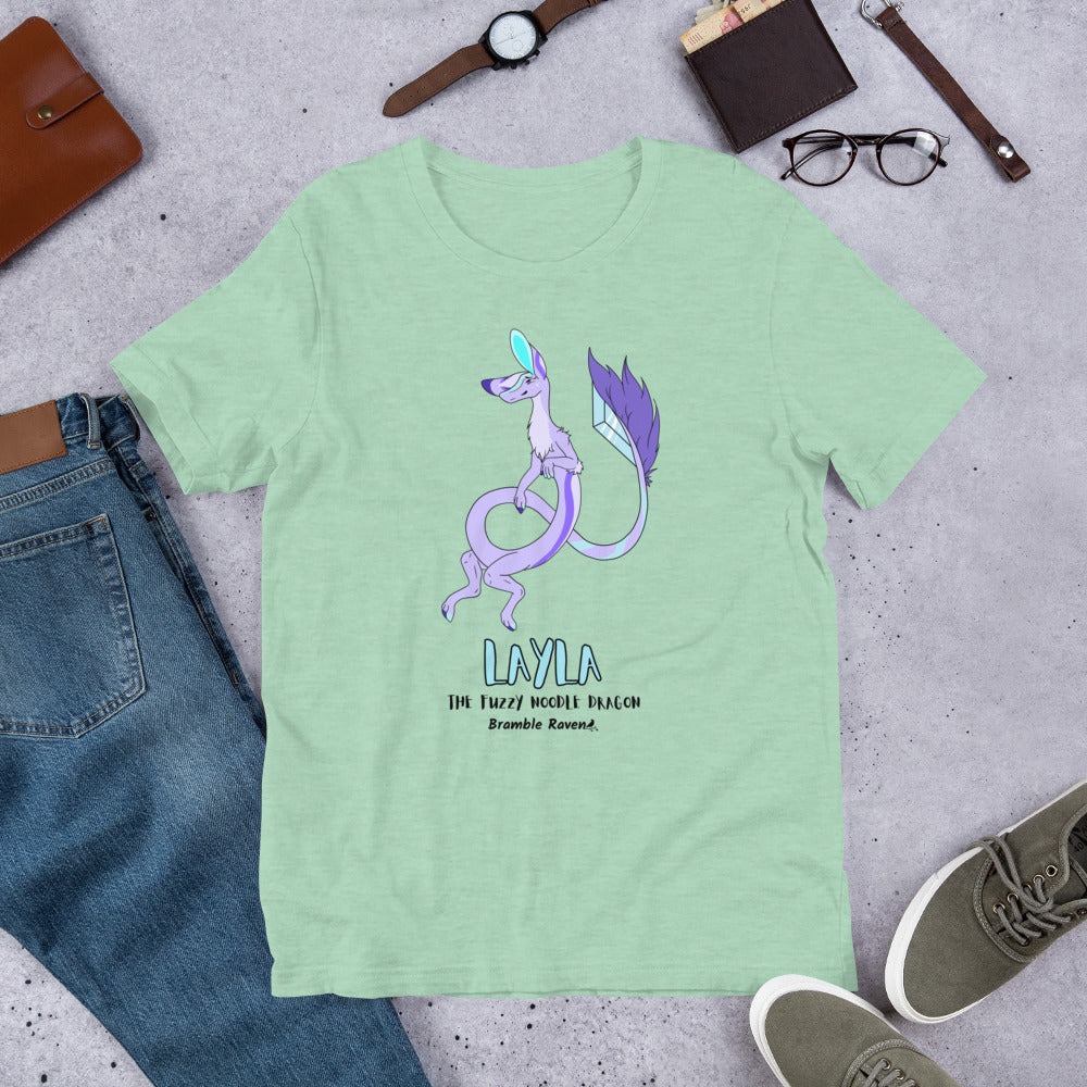 Layla the Fuzzy Noodle Dragon on a heather prism mint green unisex t-shirt. Shown surrounded by pants, shoes, glasses, a watch, and wallet.