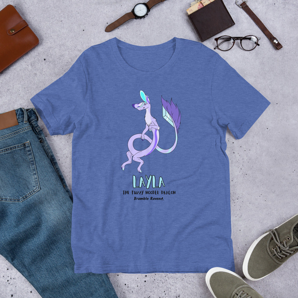 Layla the Fuzzy Noodle Dragon on a heather true royal blue unisex t-shirt. Shown surrounded by pants, shoes, glasses, a watch, and wallet.