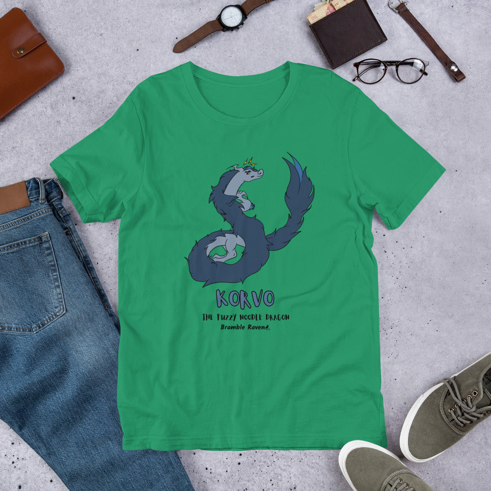 Korvo the angry Fuzzy Noodle Dragon on a kelly green unisex t-shirt. Shown surrounded by pants, shoes, glasses, a watch, and wallet.