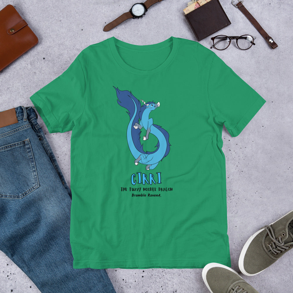 Cirri the Fuzzy Noodle Dragon on a kelly green unisex t-shirt. Shown surrounded by pants, shoes, glasses, a watch, and wallet.