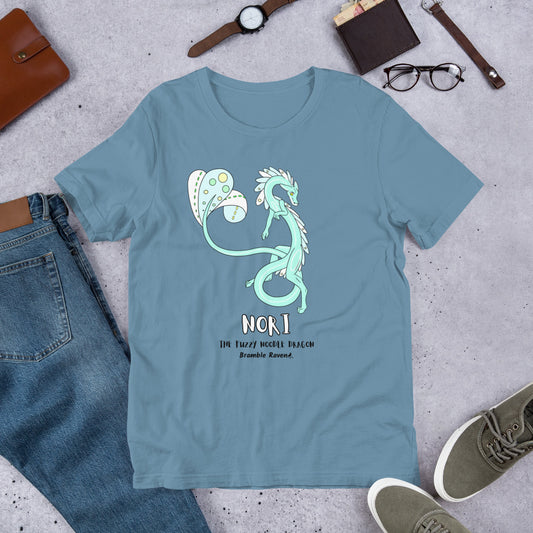 Steel blue colored unisex t-shirt featuring original fantasy design Nori the Fuzzy Noodle Dragon. Image shows flat lay by pants, wallet, glasses, shoes, and watch.