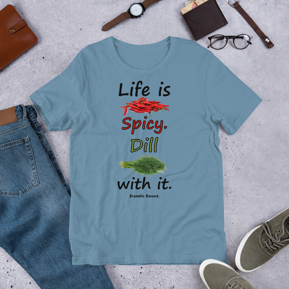 Steel blue colored unisex t-shirt. Features text: Life is Spicy. Dill with it. Graphic of chili peppers and dill weed. Made of preshrunk cotton with side seams. Shown on floor by pants, shoes, wallet and glasses.