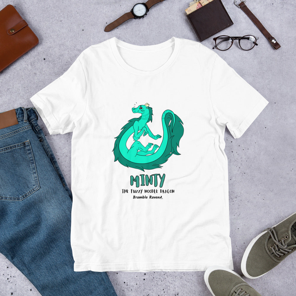 Minty the Fuzzy Noodle Dragon on a white unisex t-shirt. Shown surrounded by pants, shoes, glasses, a watch, and wallet.