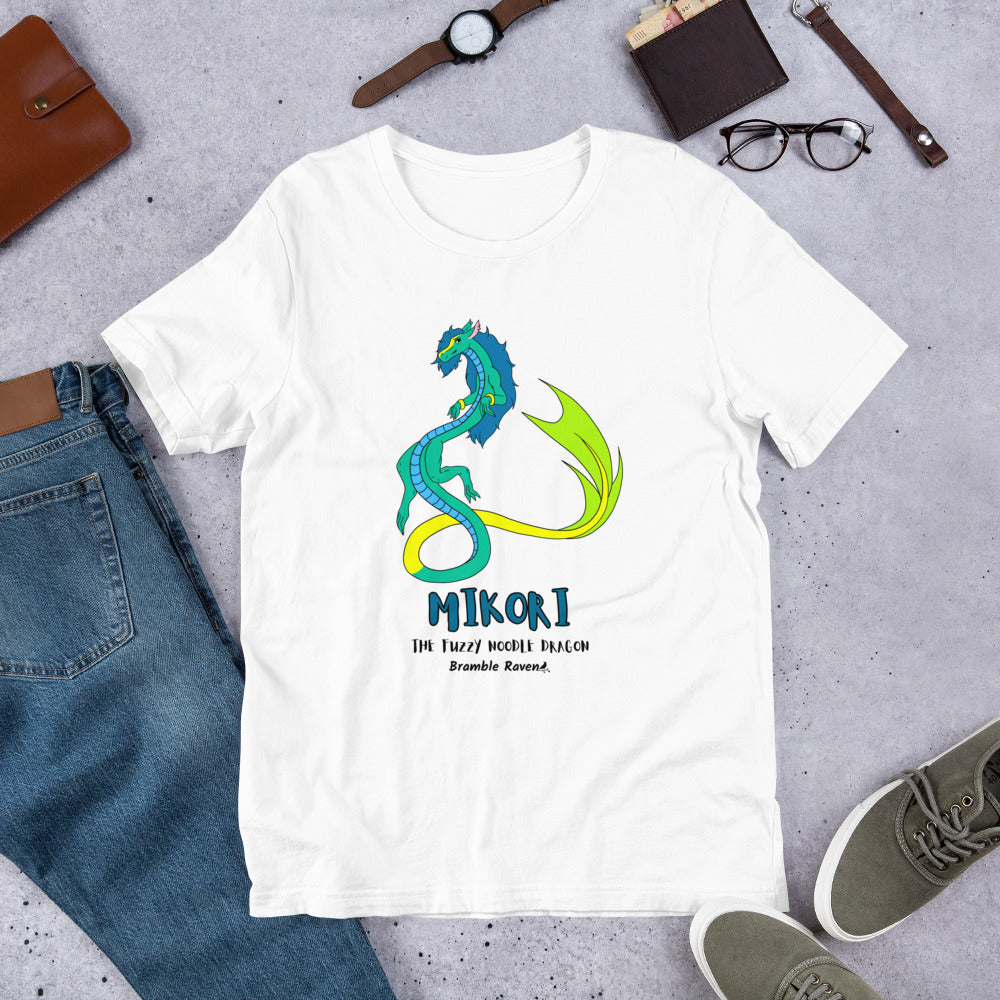 Mikori the Fuzzy Noodle Dragon on a white unisex t-shirt. Shown surrounded by pants, shoes, glasses, a watch, and wallet.