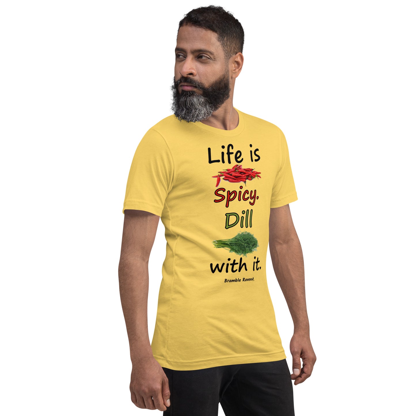 Yellow colored unisex t-shirt. Features text: Life is Spicy. Dill with it. Graphic of chili peppers and dill weed. Made of preshrunk cotton with side seams. Shown on male model facing right.