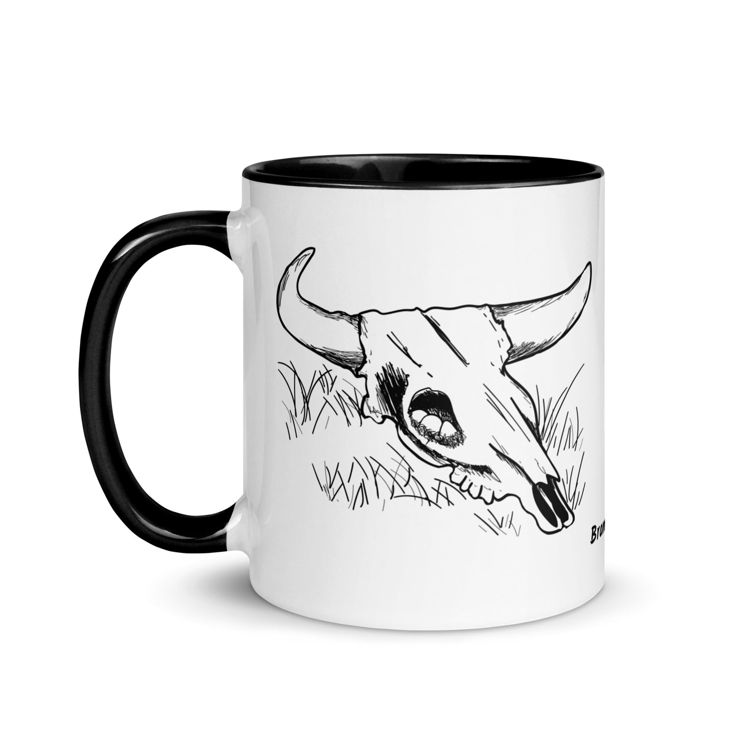 11 ounce ceramic mug. White with black handle and inside. Features double sided image of a cow skull cradling a bird nest.