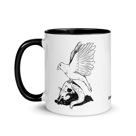 11 ounce white ceramic mug with black handle and inside. Features a double sided print of Reflections, a design with a crow sitting on a sheep skull. Dishwasher and microwave safe.