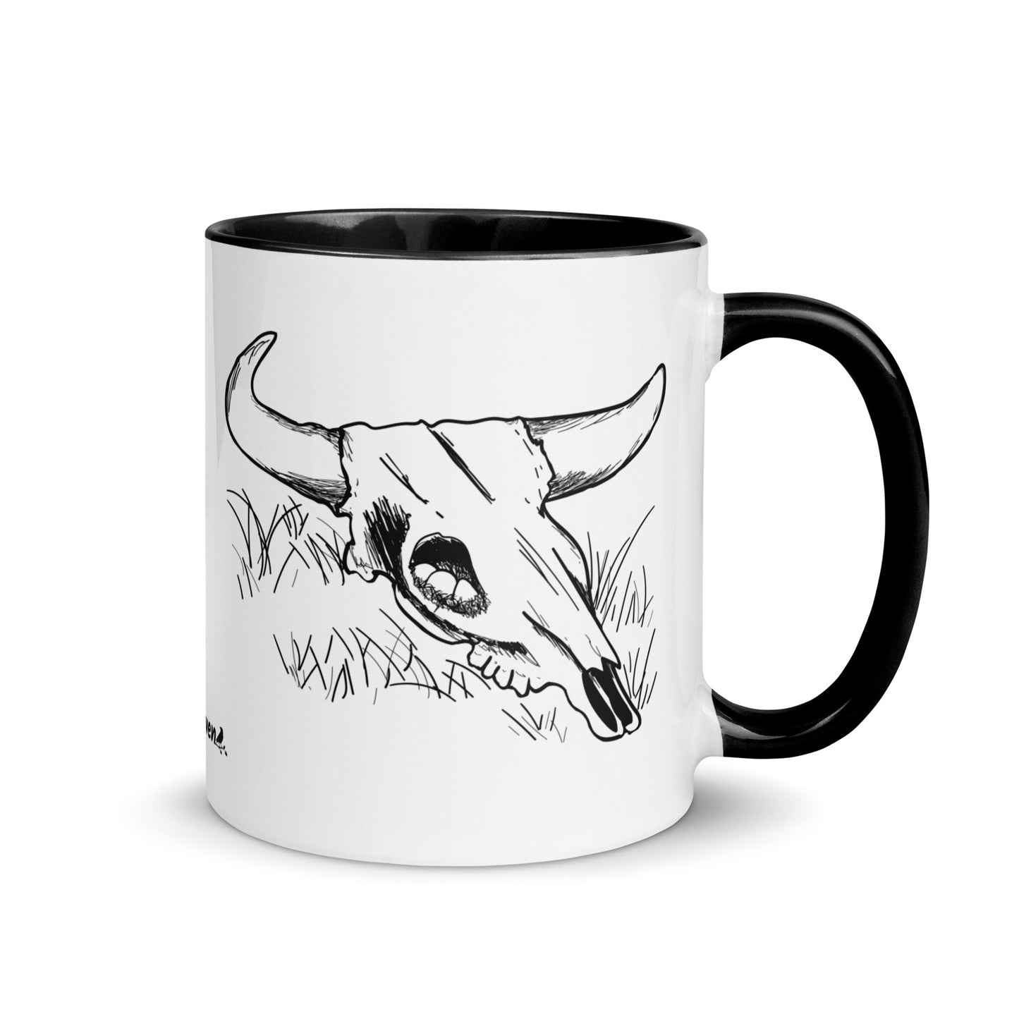 11 ounce ceramic mug. White with black handle and inside. Features double sided image of a cow skull cradling a bird nest.
