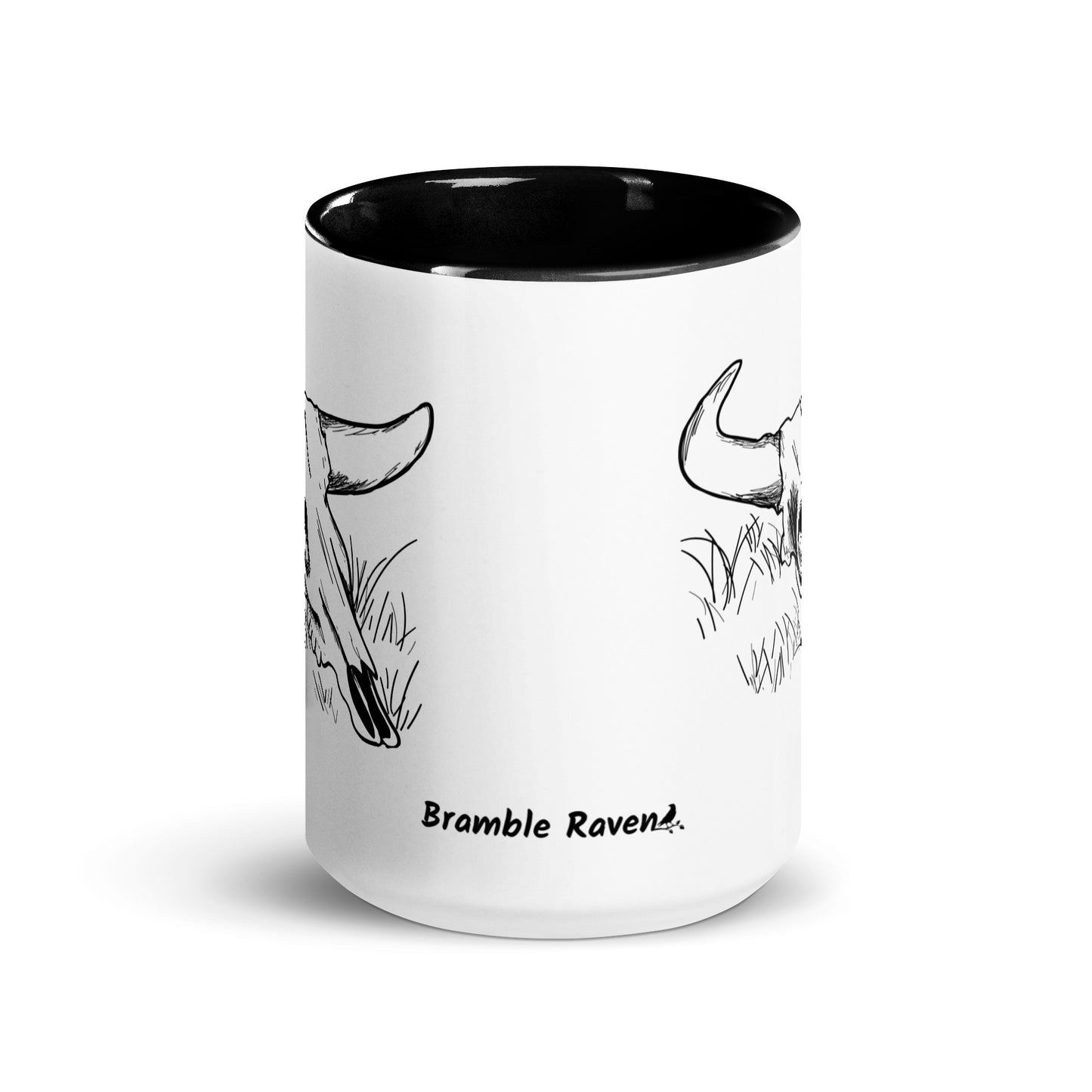 15 ounce ceramic mug. White with black handle and inside. Features double sided image of a cow skull cradling a bird nest. Front view.