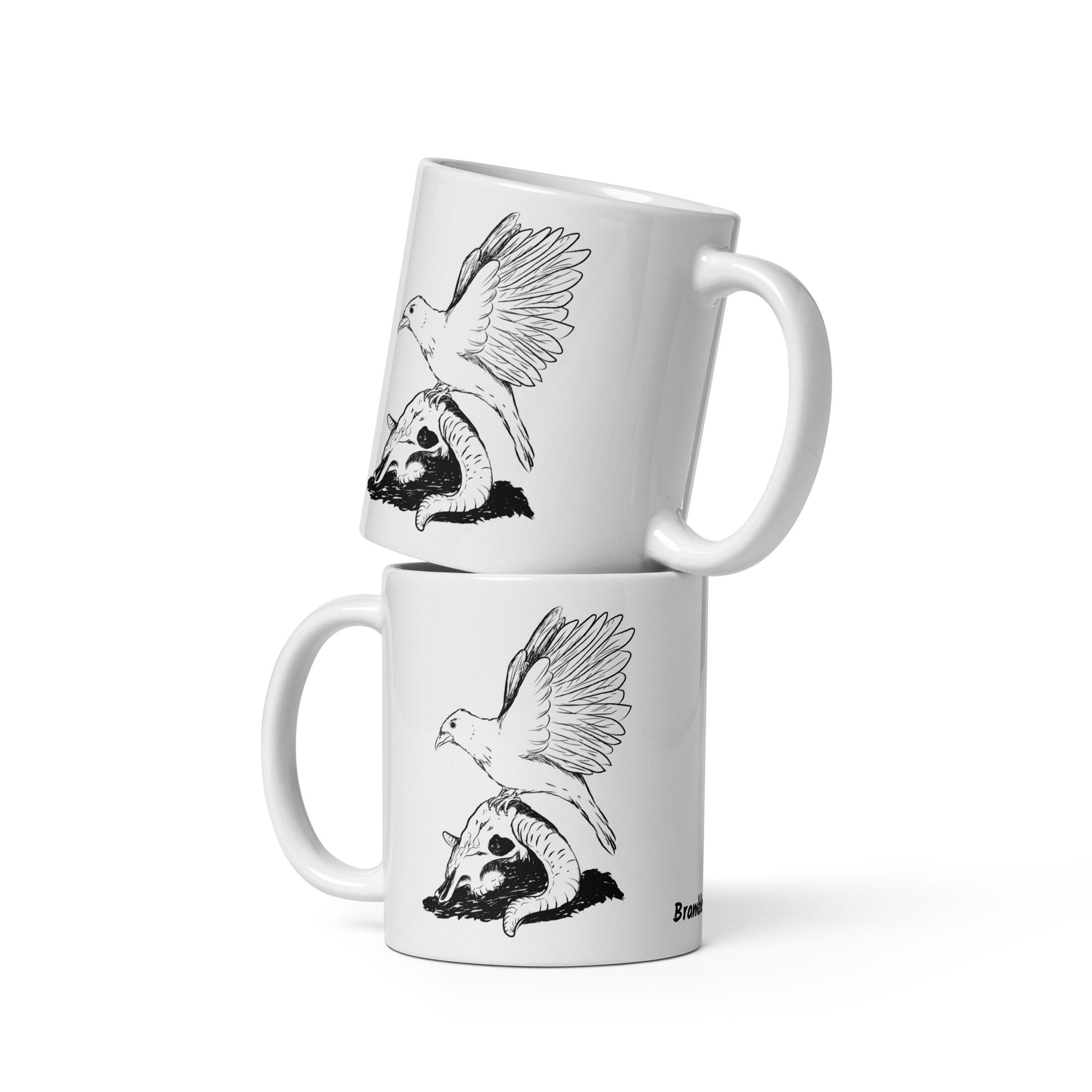 11 ounce white glossy mug featuring double sided print of Reflections, a design with a crow with wings outstretched on a sheep skull. Two mugs shown stacked on each other.