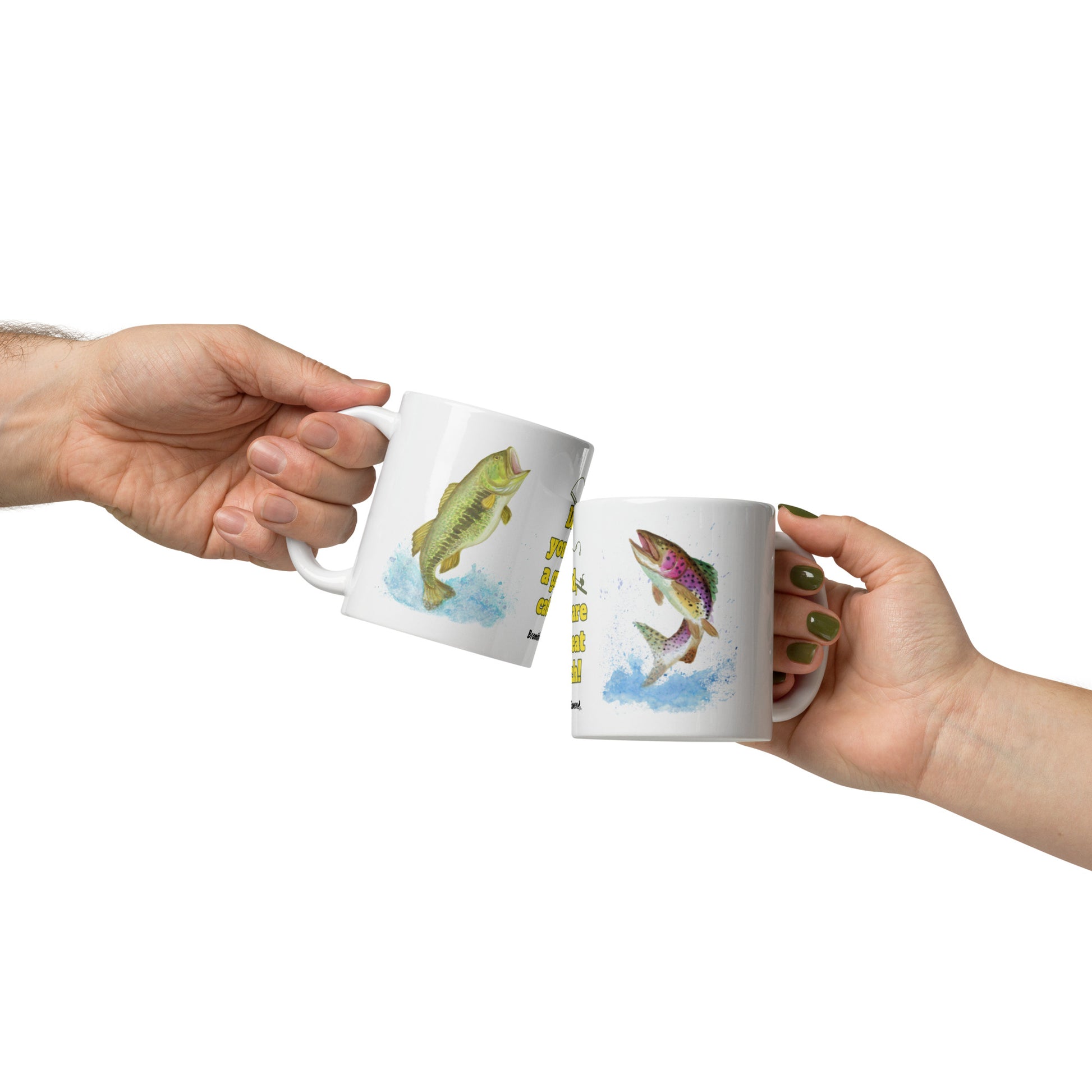 11 ounce ceramic mug. Features watercolor print of a rainbow trout and a largemouth bass with text that says: Dad, you are a great catch! Image shows two mugs in two hands.