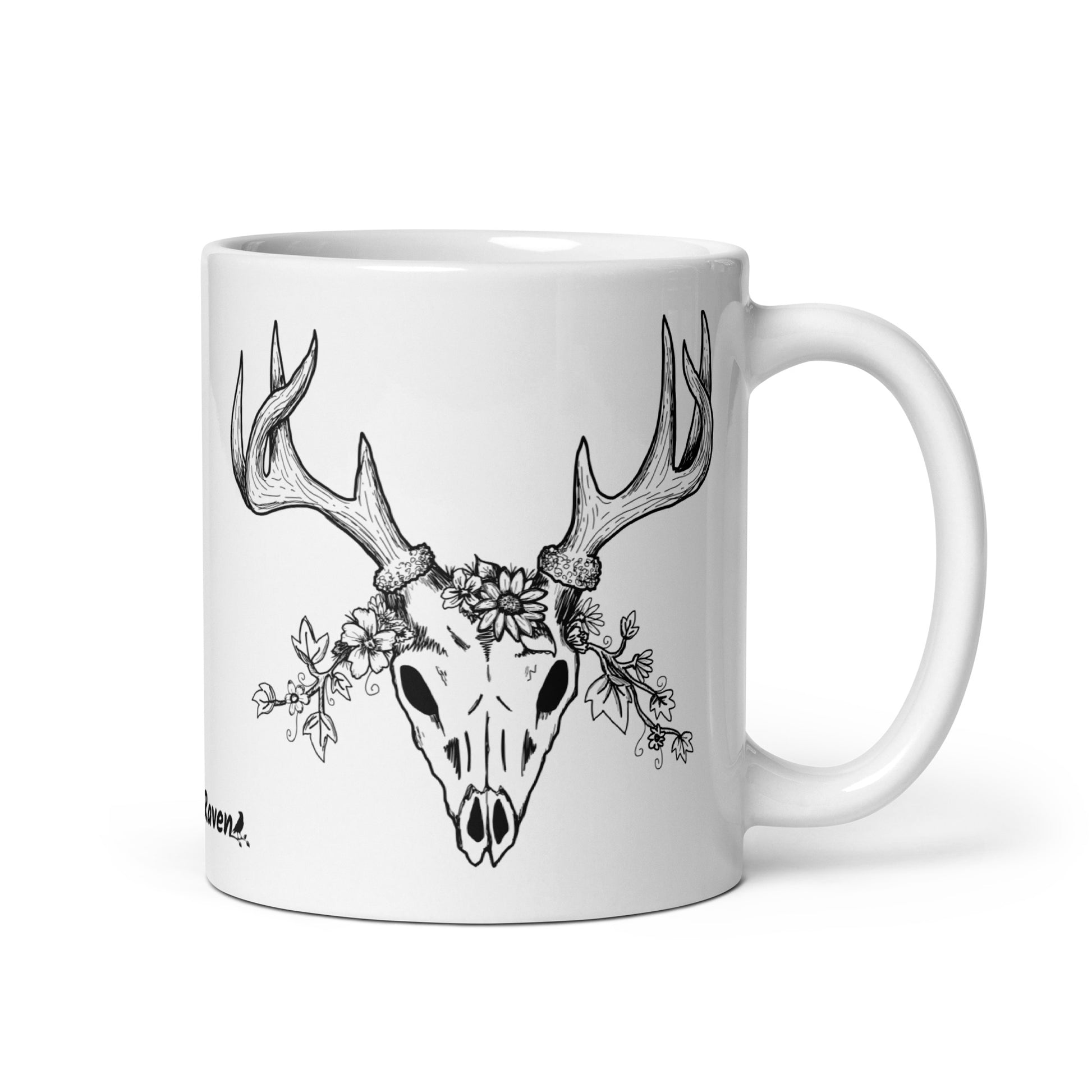 11 oz white ceramic mug. Features a double-sided hand illustrated image of a deer skull wreathed in flowers.