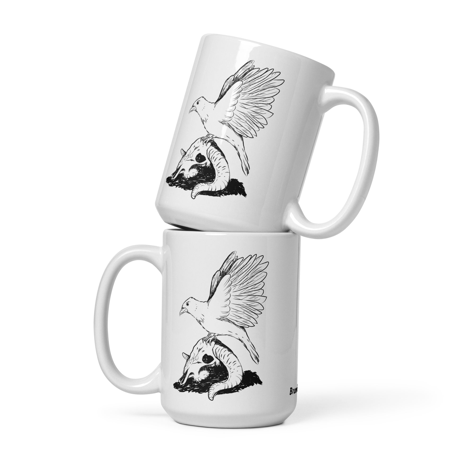 15 ounce white glossy mug featuring double sided print of Reflections, a design with a crow with wings outstretched on a sheep skull. Two mugs shown stacked on each other.