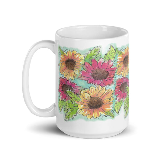 15 ounce white ceramic mug. Features a wraparound print of Gerber daisies painted in watercolor by Heather Silver. Mug is dishwasher and microwave safe.